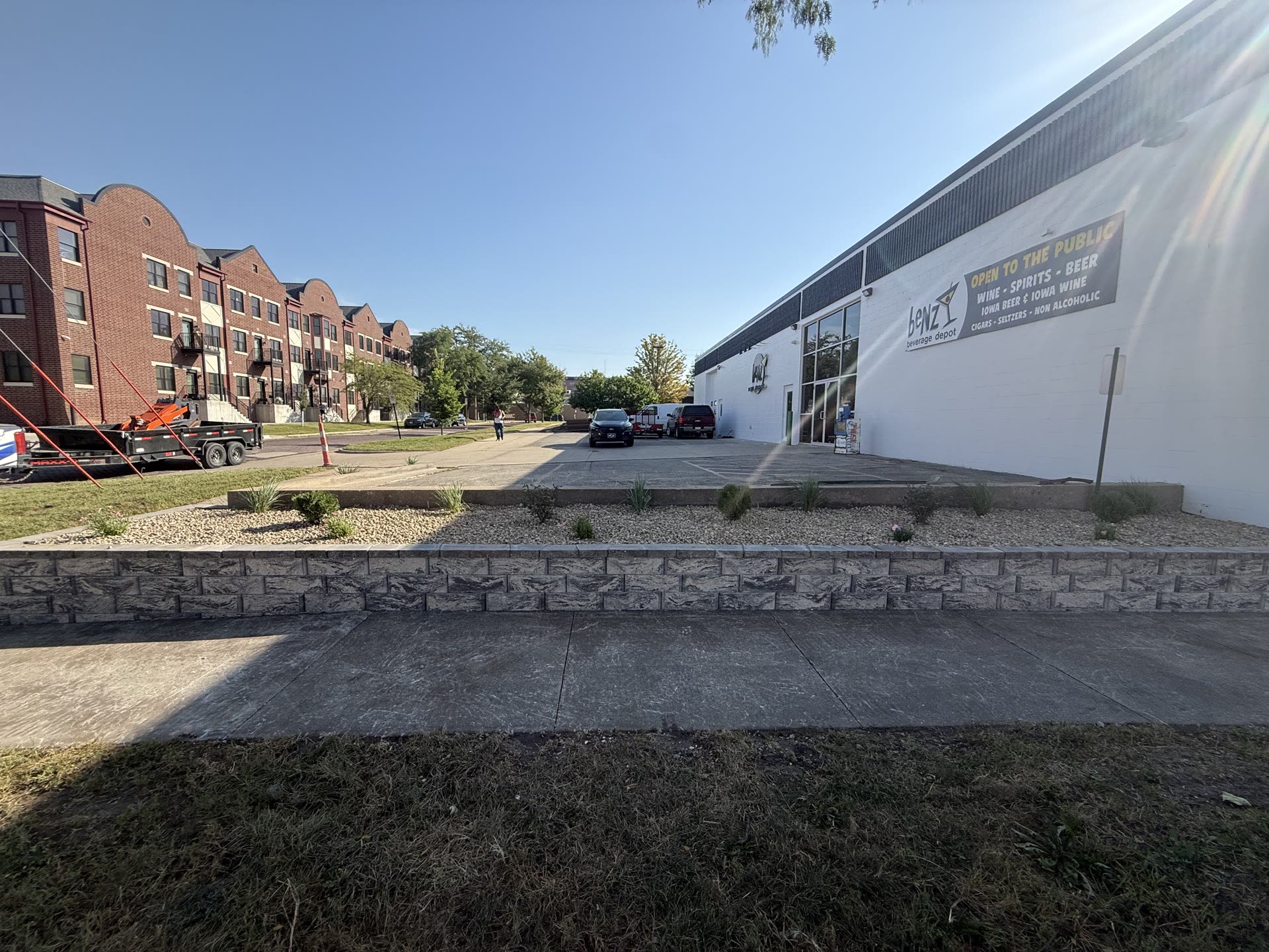 Long stone retaining wall running the length of a commercial building